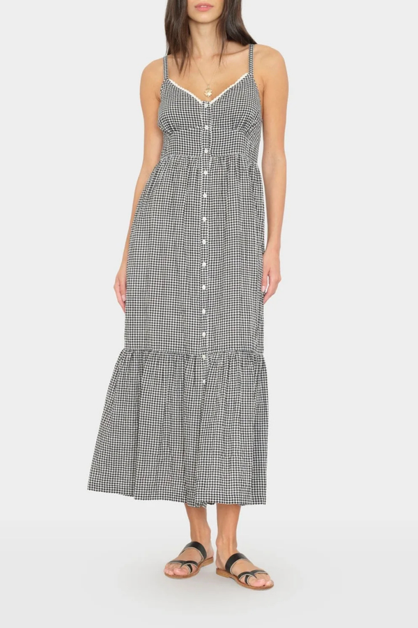 front profile model wearing Greta Gingham Dress black sand cotton Balboa Gingham Mini Check
Button-front
Midi dress
V-neck
Adjustable straps
Fitted bodice
Tiered skirt
Side seam pockets
Smocked back