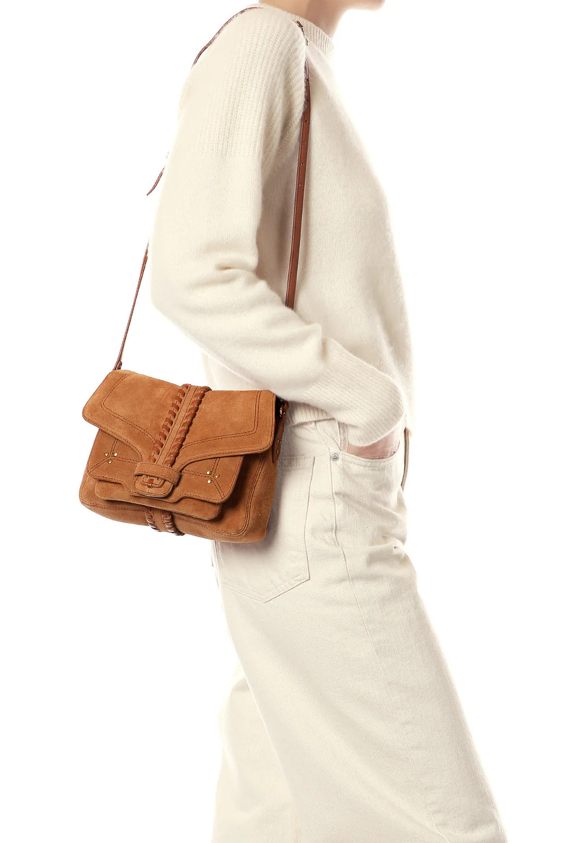 side profile model wearing on shoulder Harry S Suede Caramel Shoulder Bag Adjustable leather shoulder strap worn over the shoulder or crossbody
Closure with a hand-braided flap
Loop fastening
Hand-braided flap fastens with a loop
Dimensions: 20cm x 16cm x 7cm
Bag 80% calfskin split 20% Goat / Lining 100% cotton