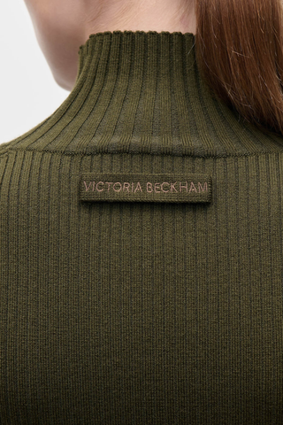 close up back logo detail for High Neck Jumper marsh green High neck
Fine merino
Close fit
Elevated neckline
Fine Merino Rib
Victoria Beckham embroidered detail at back neck
88% Merino Wool 11% Polyamide 1% Elastane