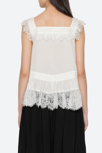 back profile model wearing  Hilda Solid Sleeveless Top White Soft v-neckline
Framed with floral lace trim
Fine pleated detailing
cotton nylon blend
Invisible side zipper