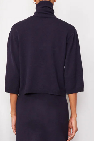 back profile model wearing Jalila Sweater Dark Navy boxy fit cashmere wool turtleneck with half sleeves