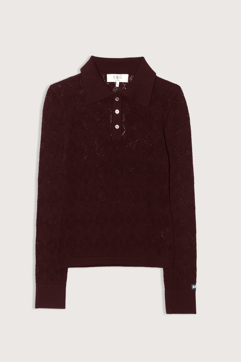 flat lay Jane Polo Sweater Burgundy Argyle polo sweater
Intricate argyle knit
Long sleeves
Custom patch at the sleeve
100% merino wool
Partial button front
Slimmer fit