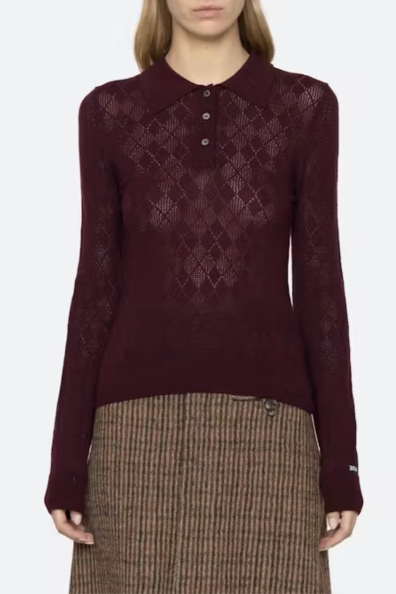 front profile model wearing Jane Polo Sweater Burgundy Argyle polo sweater
Intricate argyle knit
Long sleeves
Custom patch at the sleeve
100% merino wool
Partial button front
Slimmer fit