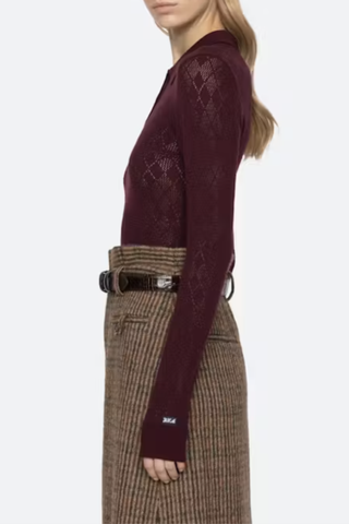 side profile model wearing Jane Polo Sweater Burgundy Argyle polo sweater
Intricate argyle knit
Long sleeves
Custom patch at the sleeve
100% merino wool
Partial button front
Slimmer fit