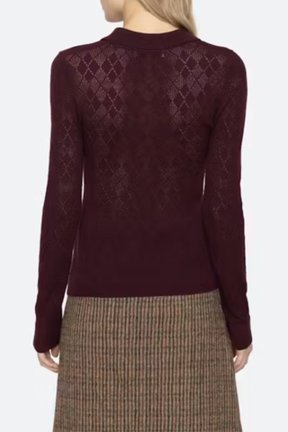 back profile model wearing Jane Polo Sweater Burgundy Argyle polo sweater
Intricate argyle knit
Long sleeves
Custom patch at the sleeve
100% merino wool
Partial button front
Slimmer fit