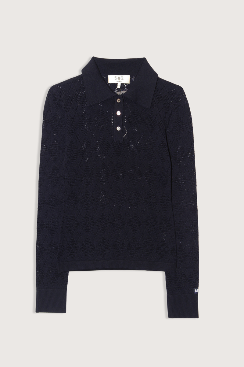 flat lay Jane Polo Sweater Navy Argyle polo sweater
Intricate argyle knit
Long sleeves
Custom patch at the sleeve
100% merino wool
Partial button front

Slimmer fit