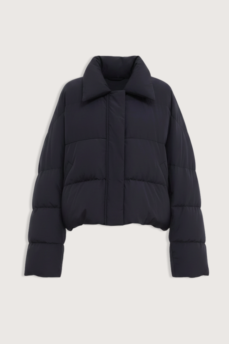 flat lay Jani Puffer Jacket Black Cropped signature down jacket
Soft water-repellent nylon
Oversized silhouette
Voluminous sleeves
Statement collar
Concealed snap buttons
Zip closure
Adjustable drawcord hem
100% Nylon
