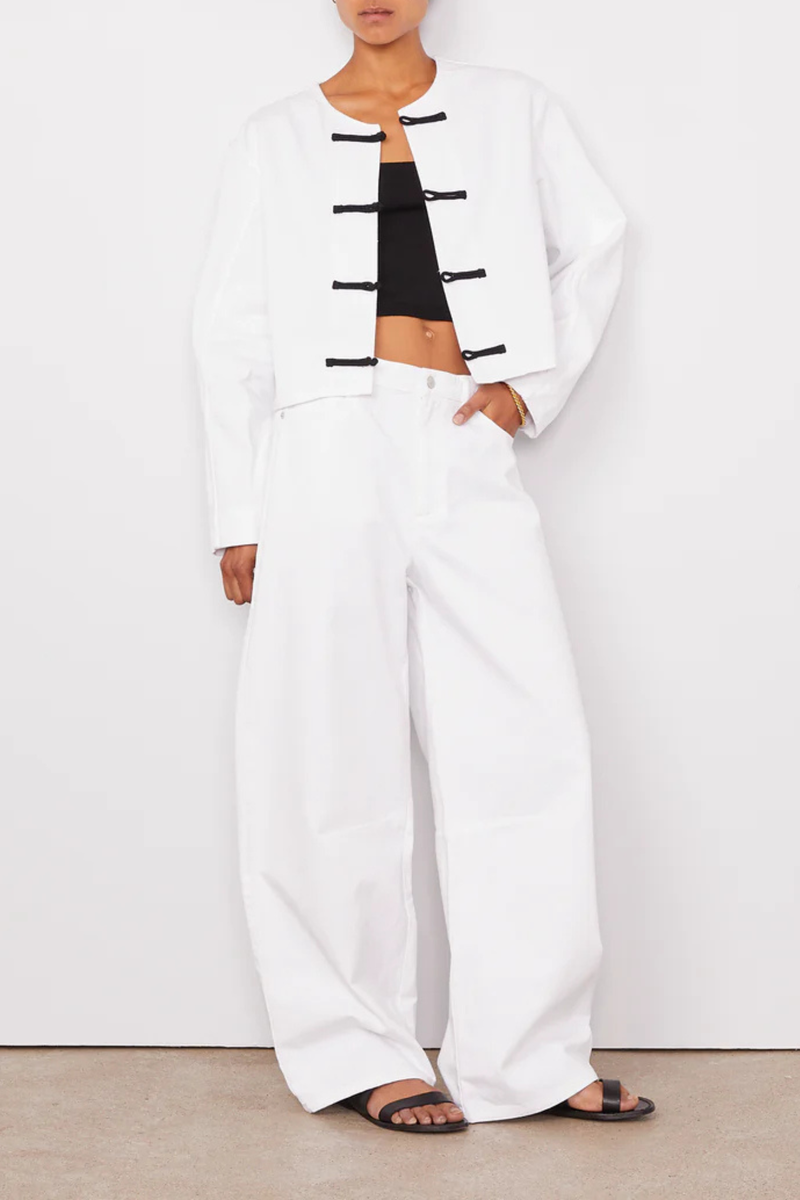 front profile model wearing  Joelle Jacket White Denim Short buttoned straight fit jacket
100% Oragnic Cotton
Round sleeves with darts and undersleeves yokes
Contrasted closing