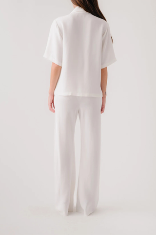 back profile model wearing Kalleen Short Sleeve Collared Silk Top Single button closure
100% Silk