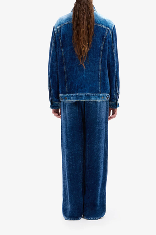 back profile model wearing Kankam Velvet Pants denim print effect wide straight leg blue