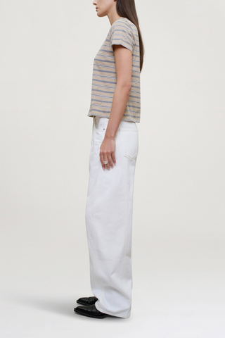 side profile model wearing Kenzie Stripe Short Sleeve T-Shirt Almond Stripe
Handmade custom stripe
Relaxed boxy fit
Subtle cropped length
Roomy sleeves
Slight taper at waist
Shifted side seams give tailored look
Solid knit binding at neckline
Features contrast Kallmeyer embroidery at hem
100% Cotton