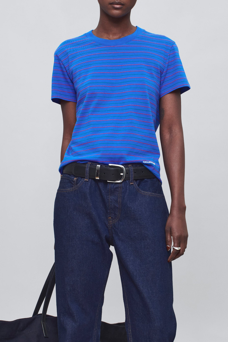 front profile model wearing  Kenzie Stripe Short Sleeve T-Shirt Cobalt blue
Relaxed boxy crop
crewneck
Features contrast Kallmeyer embroidery at hem
100% Cotton