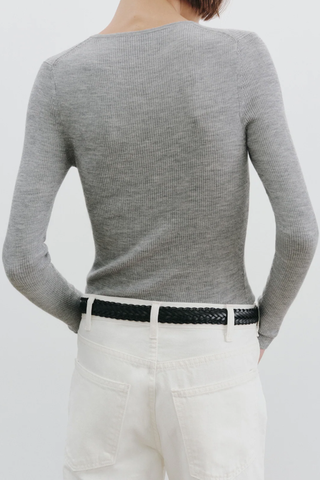 back profile model wearing  Klarise Henley Knit medium grey melange wool silk blend Slim fit fine gauge pullover
Long sleeve henley
Regular length
Faux horn button closure
Tubular neck trim