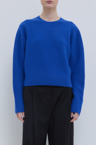 front profile model wearing Kopanos Long Sleeve Crew Klein Blue 100% Superfine Merino Wool regular fit