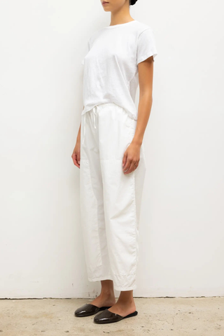 side profile model wearing Kyoto Carpenter Pant White cotton Classic utility inspired trouser
Pull-on style
Baggy leg silhouette
Hits at the ankle
Topstitched utility panels at front
Adjustable waistband
Patch pockets at back