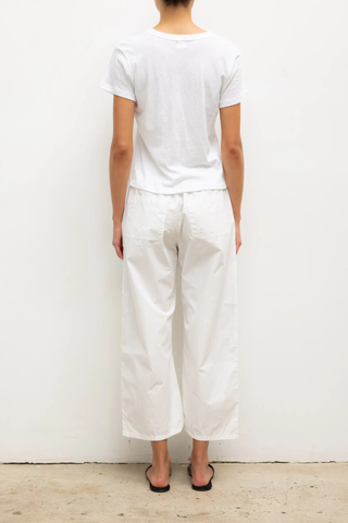 back profile model wearing Kyoto Carpenter Pant White cotton Classic utility inspired trouser
Pull-on style
Baggy leg silhouette
Hits at the ankle
Topstitched utility panels at front
Adjustable waistband
Patch pockets at back