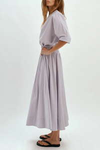 side profile model wearing Kyria Poplin Striped Skirt Chambray/Poppy Stripe Full skirt
Elastic waistband
100% cotton
