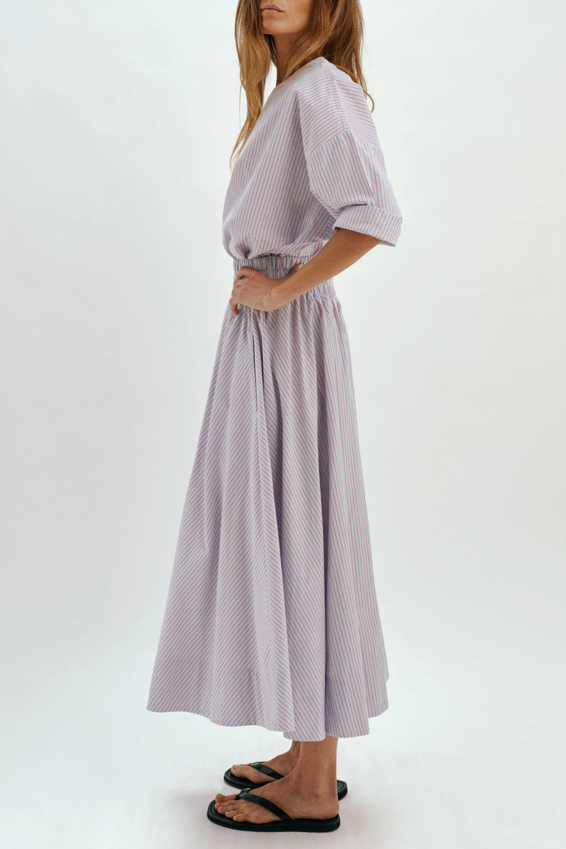 side profile model wearing Kyria Poplin Striped Skirt Chambray/Poppy Stripe Full skirt
Elastic waistband
100% cotton
