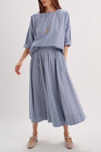 front profile model wearing Kyria Poplin Striped Skirt Navy Stripe Full skirt
Elastic waistband
100% cotton