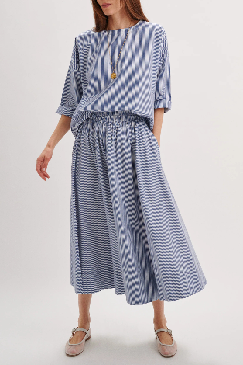 front profile model wearing Kyria Poplin Striped Skirt Navy Stripe Full skirt
Elastic waistband
100% cotton