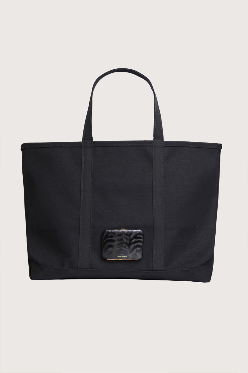 front profile L.L.Bean X Lutz Morris L Tote Bag black A collaboration with L.L.Bean &amp; Lutz Morris
Classic Boat and Tote in monochrome black
Outer pocket embossed and hand-painted calf leather to resemble lizzard with 24k gold-plated stainless steel hardware
Heavyweight canvas
Reinforced handles
Double-stitched seams

crafted in Maine, one tote at a time

Large

Capacity: Approx. 2,124 cu. in., 35 L.
Dimensions: 15"H x 17"W x 7½"D.
Handles: Regular 8", Long 14".