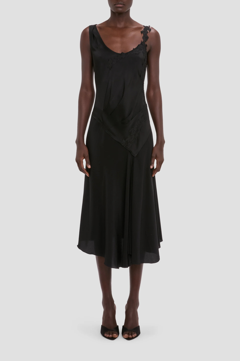 front profile model wearing Lace Strap Dress Black Ankle length with asymmetric hem
Drape fabrication
Round front neckline
Covered back
Sleeveless
Trim lace detail
Zip fastening