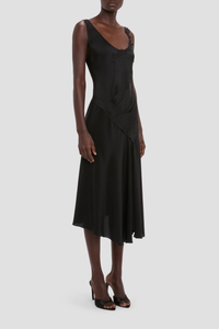 side profile model wearing Lace Strap Dress Black Ankle length with asymmetric hem
Drape fabrication
Round front neckline
Covered back
Sleeveless
Trim lace detail
Zip fastening