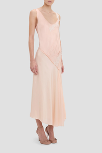 side profile model wearing Lace Strap Dress Blossom peach pink Ankle length with asymmetric hem
Drape fabrication
Round front neckline
Covered back
Sleeveless
Trim lace detail
Zip fastening
71% Acetate 29% Viscose