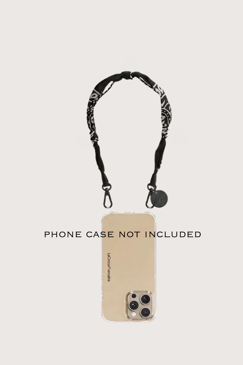 phone demonstration with Laia Short Phone Chain Noir Short phone chain
Chain easily attaches to the rings of La Coque Francaise phone cases. If you don't have a ring case, a universal adapter is available - sold separately.

Composition: cotton voile and charms
Finishes: swivel carabiners and stainless steel rings
Length: 40 cm