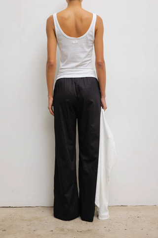 back profile model wearing  Laura Scoop Neck Tank White Scoop Neck
Classic silhouette
Lightweight
Vintage-feel
100% Cotton