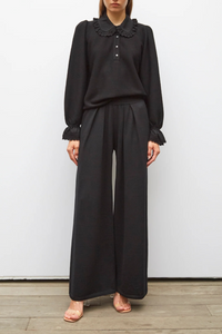 front profile model wearing Lauren Fluid Knit Trouser Black wool scallop waistband