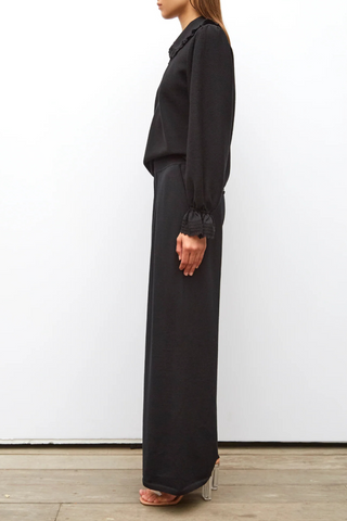 side profile model wearing Lauren Fluid Knit Trouser Black wool scallop waistband