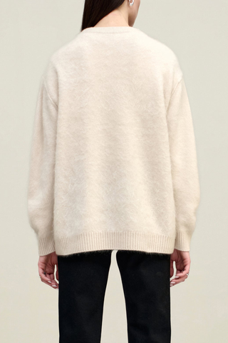 back profile model wearing Lena V-neck Brushed Cashmere Sweater coconut white oversized fit dropped shoulders long sleeve