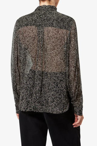 back profile model wearing Leona Printed Top black ecru Lightweight printed muslin blouse
Stand-up collar with pussy bow
Long sleeves with buttoned cuffs
Asymmetrical opening