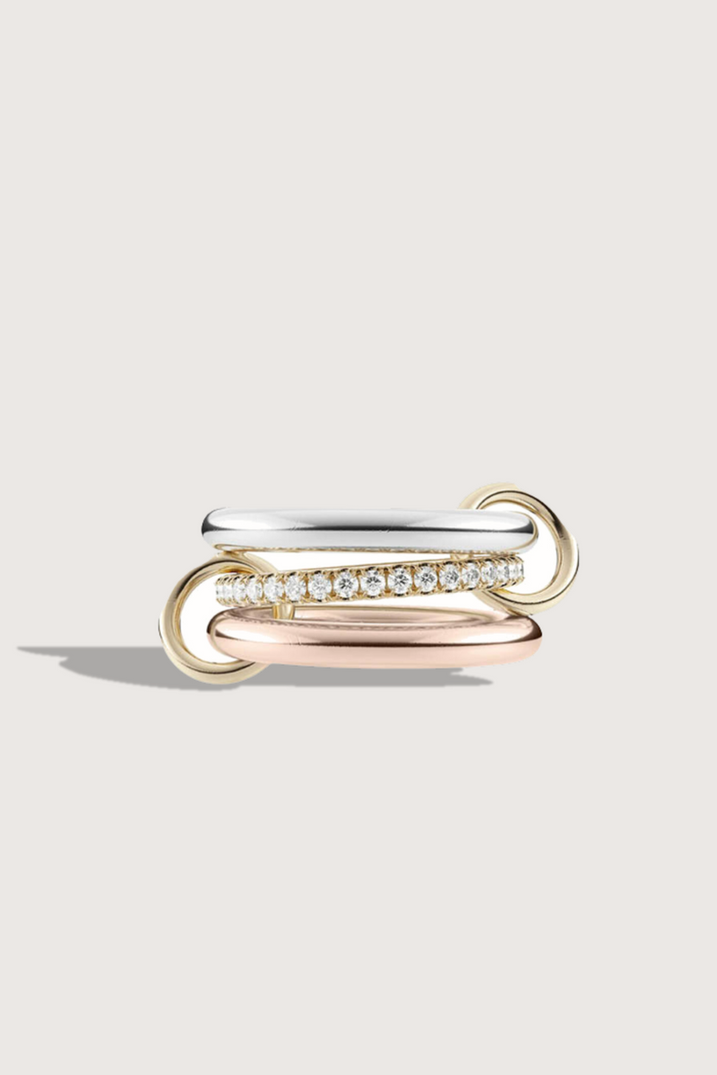 flat lay Libra Petite Mx  ring.  three bands of .925 sterling silver and 18k yellow gold with pavé white diamonds and 18k yellow gold connectors. 