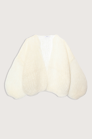 flat lay Light Mohair Bomber Cardigan Creme Relaxed bomber shape that frames the shoulders
Ultra-light mohair knit created from a single yarn strand
Airy texture that adds subtle depth without weight
75% Mohair, 20% Wool, and 5% Polyamide