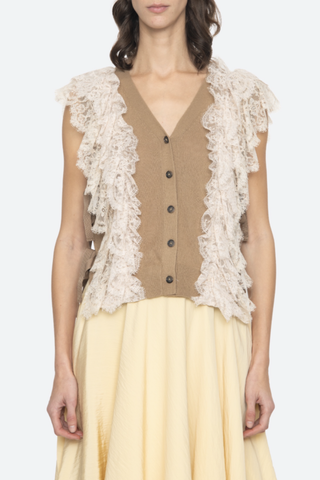 front profile model wearing Lisette Solid Sweater Vest khaki Lace Detail
V-neckline
Button front closure
Wool lace combo
Cap sleeve
Tie detail on the side
Self: 100% Wool | Decoration: 100% Polyamide