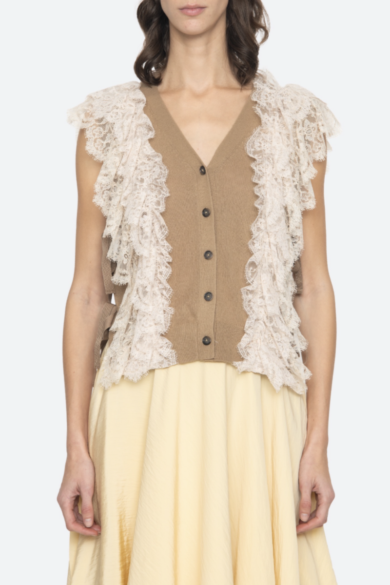 front profile model wearing Lisette Solid Sweater Vest khaki Lace Detail
V-neckline
Button front closure
Wool lace combo
Cap sleeve
Tie detail on the side
Self: 100% Wool | Decoration: 100% Polyamide