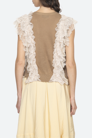back profile model wearing Lisette Solid Sweater Vest khaki Lace Detail
V-neckline
Button front closure
Wool lace combo
Cap sleeve
Tie detail on the side
Self: 100% Wool | Decoration: 100% Polyamide