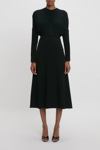 front profile model wearing Long Sleeve Dolman Midi Dress Black Long sleeve
Round neckline
Defined waist
Draped feature at sleeve underarm, fitted sleeve through the forearm
Midi length silhouette
Tonal topstitching
voluminous underarm drape
Fitted at the waist and more relaxed fit through bodice and hip
Concealed zip with hook and eye closure at back
Concealed zip opening at cuff