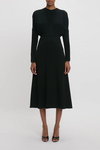 front profile model wearing Long Sleeve Dolman Midi Dress Black Long sleeve
Round neckline
Defined waist
Draped feature at sleeve underarm, fitted sleeve through the forearm
Midi length silhouette
Tonal topstitching
voluminous underarm drape
Fitted at the waist and more relaxed fit through bodice and hip
Concealed zip with hook and eye closure at back
Concealed zip opening at cuff