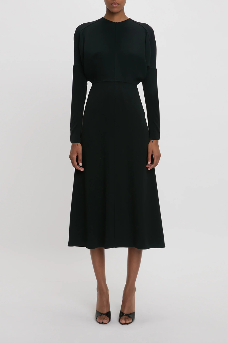 front profile model wearing Long Sleeve Dolman Midi Dress Black Long sleeve
Round neckline
Defined waist
Draped feature at sleeve underarm, fitted sleeve through the forearm
Midi length silhouette
Tonal topstitching
voluminous underarm drape
Fitted at the waist and more relaxed fit through bodice and hip
Concealed zip with hook and eye closure at back
Concealed zip opening at cuff