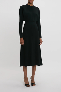 side profile model wearing Long Sleeve Dolman Midi Dress Black Long sleeve
Round neckline
Defined waist
Draped feature at sleeve underarm, fitted sleeve through the forearm
Midi length silhouette
Tonal topstitching
voluminous underarm drape
Fitted at the waist and more relaxed fit through bodice and hip
Concealed zip with hook and eye closure at back
Concealed zip opening at cuff