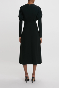 back profile model wearing Long Sleeve Dolman Midi Dress Black Long sleeve
Round neckline
Defined waist
Draped feature at sleeve underarm, fitted sleeve through the forearm
Midi length silhouette
Tonal topstitching
voluminous underarm drape
Fitted at the waist and more relaxed fit through bodice and hip
Concealed zip with hook and eye closure at back
Concealed zip opening at cuff