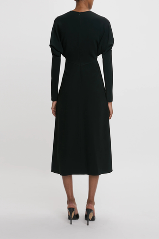 back profile model wearing Long Sleeve Dolman Midi Dress Black Long sleeve
Round neckline
Defined waist
Draped feature at sleeve underarm, fitted sleeve through the forearm
Midi length silhouette
Tonal topstitching
voluminous underarm drape
Fitted at the waist and more relaxed fit through bodice and hip
Concealed zip with hook and eye closure at back
Concealed zip opening at cuff