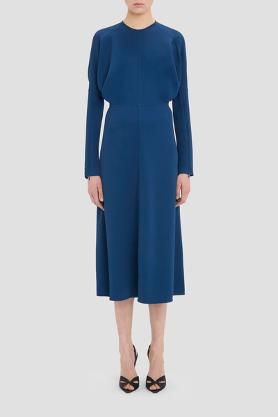 front profile model wearing long Sleeve Dolman Midi Dress Dark Ocean blue Dolman long sleeve
Round neckline
Defined waist
Draped feature at sleeve underarm, fitted sleeve through the forearm
Midi length 
Tonal topstitching
voluminous underarm drape
Fitted at the waist and more relaxed fit through bodice and hip