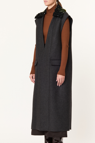 side profile model wearing Long Vest With Detachable Sequin Collar Straight-cut vest
Grey melange double wool
Removable collar embroidered with shiny and matte black sequins
Two lower pockets with horizontal rectangular flaps
71% Regenerated wool 16% Nylon 9% Polyester 4% Other fibres | LINING: 100% Cotton