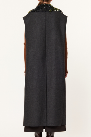 back profile model wearing Long Vest With Detachable Sequin Collar Straight-cut vest
Grey melange double wool
Removable collar embroidered with shiny and matte black sequins
Two lower pockets with horizontal rectangular flaps
71% Regenerated wool 16% Nylon 9% Polyester 4% Other fibres | LINING: 100% Cotton