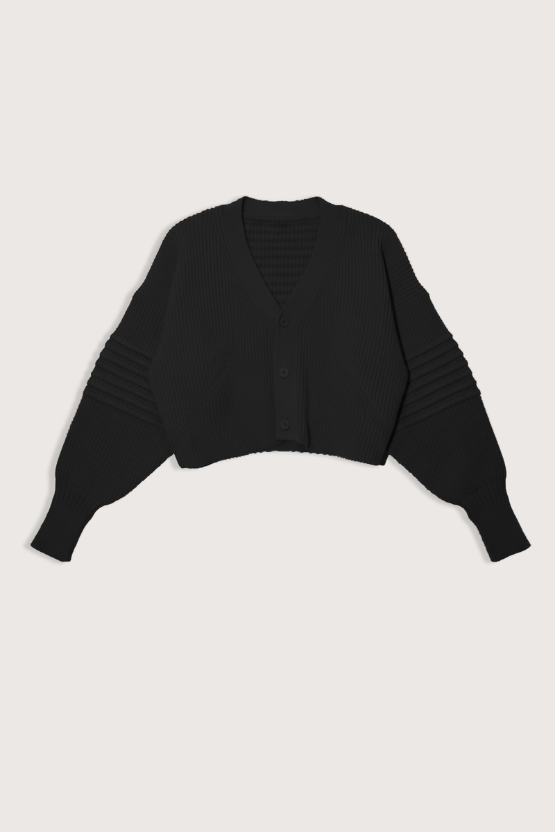 flat lay Low Gauge Cropped Cardigan Black V-neck
Button closure
Voluminous knit with a chunky gauge
Pin-tuck design on sleeves
100% Polyester