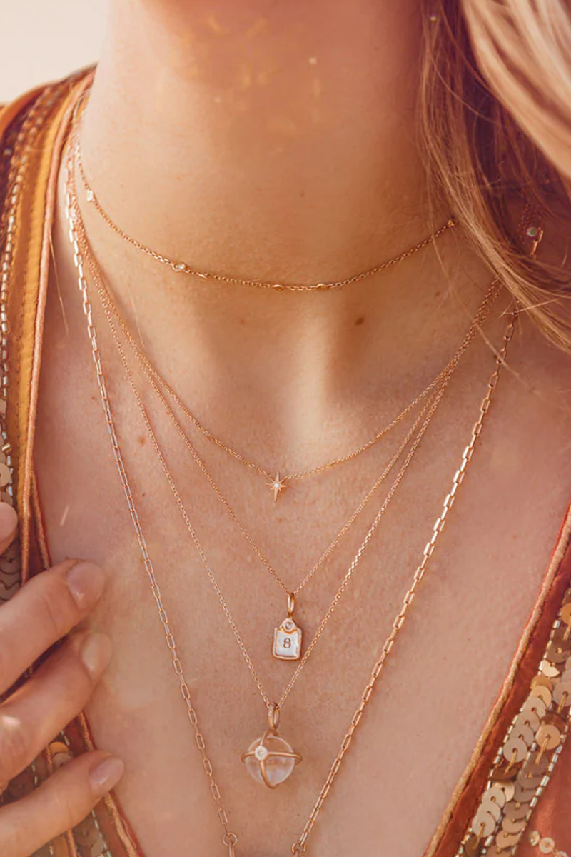 model wearing Lucky Number Charm Number 8 14k gold with rose cut diamond